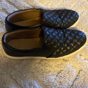 Black quilted slip ons